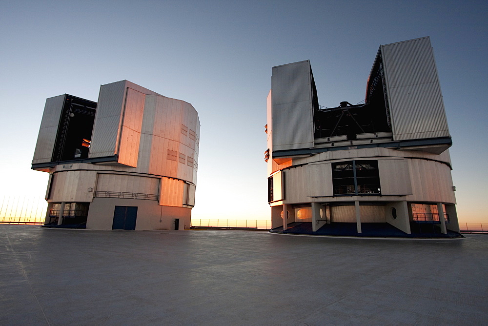 Sun Unit Telescope 1 & Moon Unit Telescope 2, Belonging To The Very Large Telescope (Vlt) Operated By The European Southern Observatory On Cerro Paranal At Sunset, Antofagasta Region, Chile