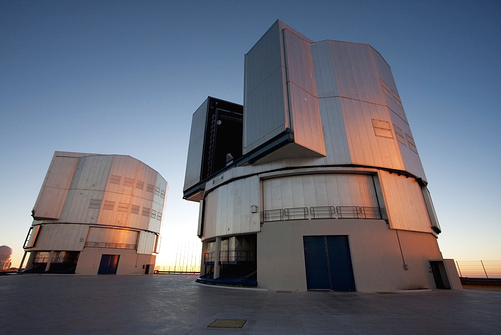 Sun Unit Telescope 1 & Moon Unit Telescope 2, Belonging To The Very Large Telescope (Vlt) Operated By The European Southern Observatory On Cerro Paranal At Sunset, Antofagasta Region, Chile