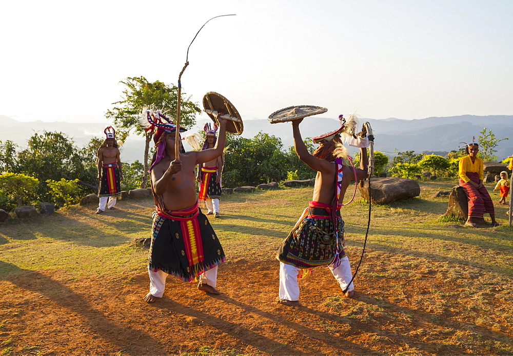 Manggarai men wearing traditional headdress wrapped with cloth using shields and bamboo whips in a caci, a ritual whip fight, Melo village, Flores, East Nusa Tenggara, Indonesia