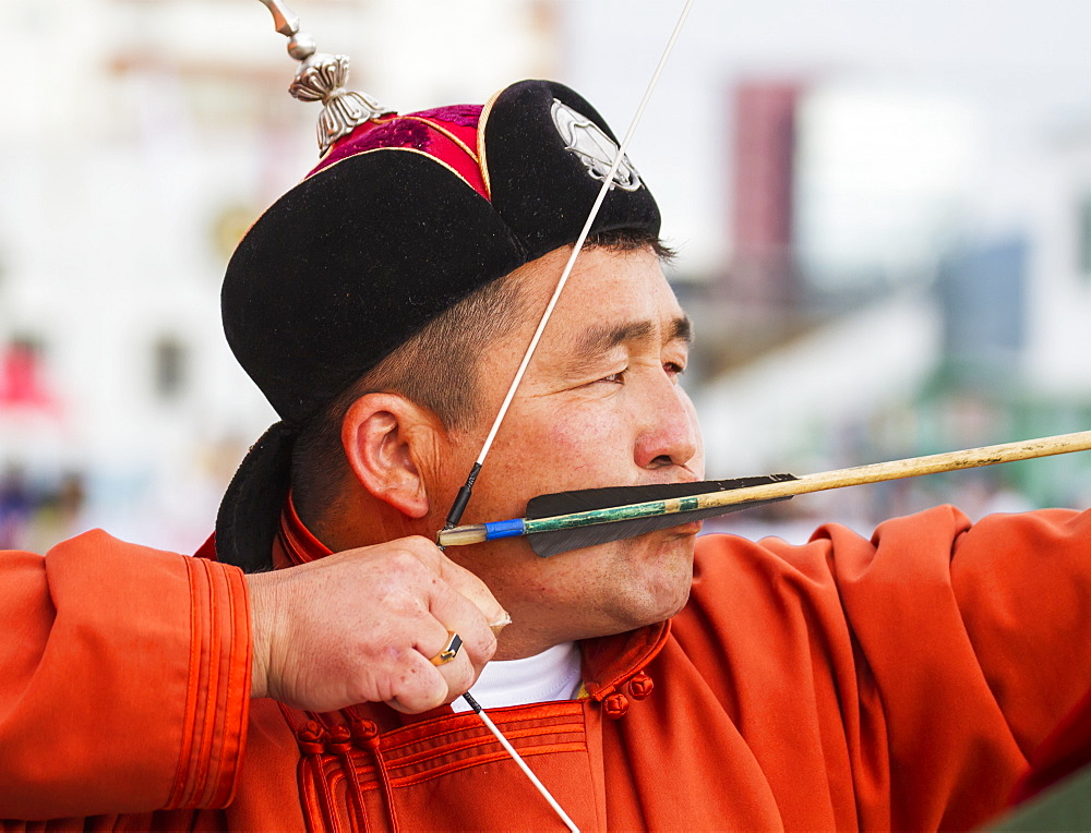 A Mongolian archer competes at the 2014 Naadam Mongolian National Festival in the archery field by the National Sports Stadium, Ulaanbaatar (Ulan Bator), Mongolia