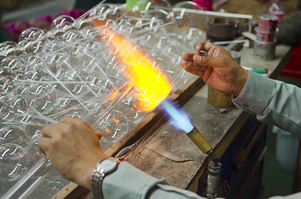 Man blowing and shaping glass, Tlalpujahua, Michoacan, Mexico