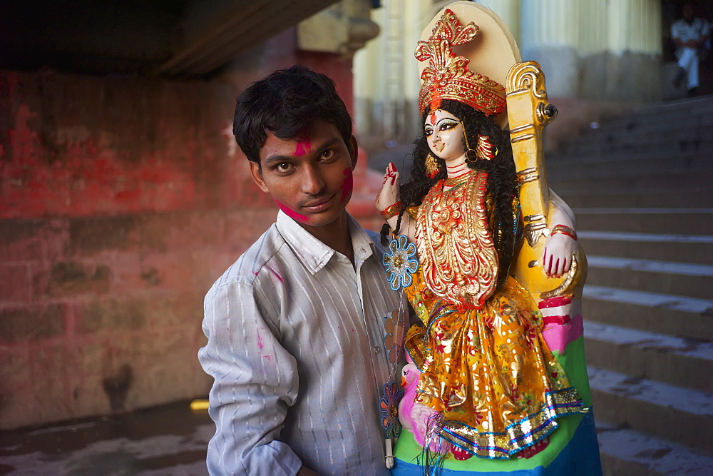 Man bringing an idol to Saraswati Puja at Babu Ghat, Kolkata, West Bengal, India