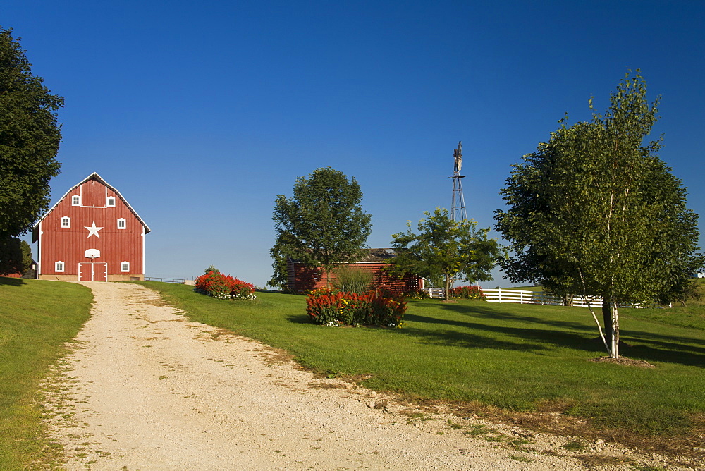 Red barn and windmill at a farm, near Edgewood, Iowa, United States of America