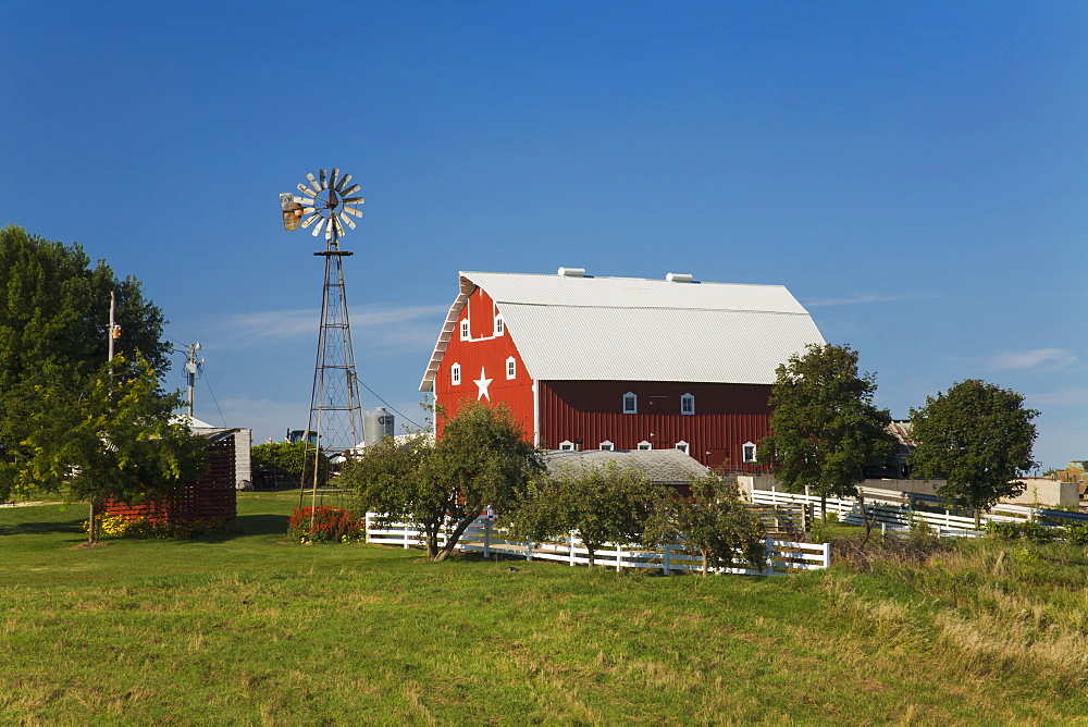 Red barn and windmill at a farm, near Edgewood, Iowa, United States of America