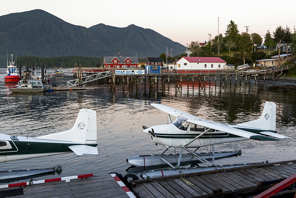 Float planes docked in Clayoquot Sound at sunset on the Pacific Rim, Vancouver Island, Tofino, British Columbia, Canada