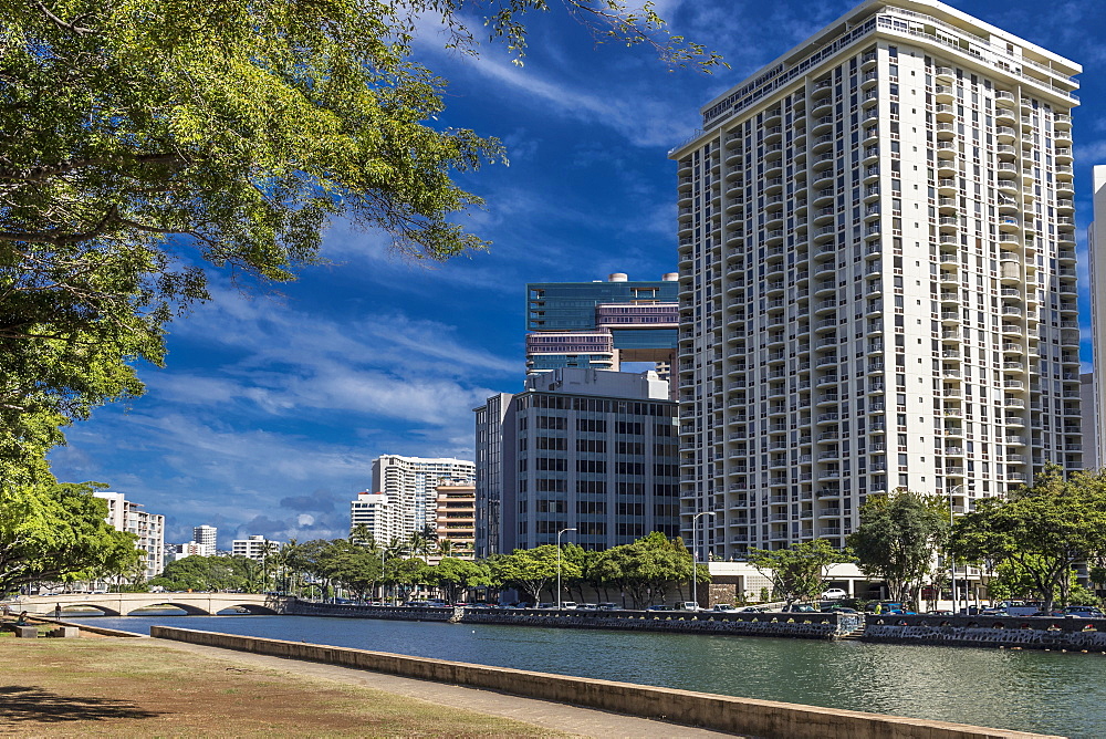 View North across Ala Wai Canal from Ala Wai Promenade towards Kalakaua Avenue bridge, Waikiki, Honolulu, Oahu, Hawaii, United States of America