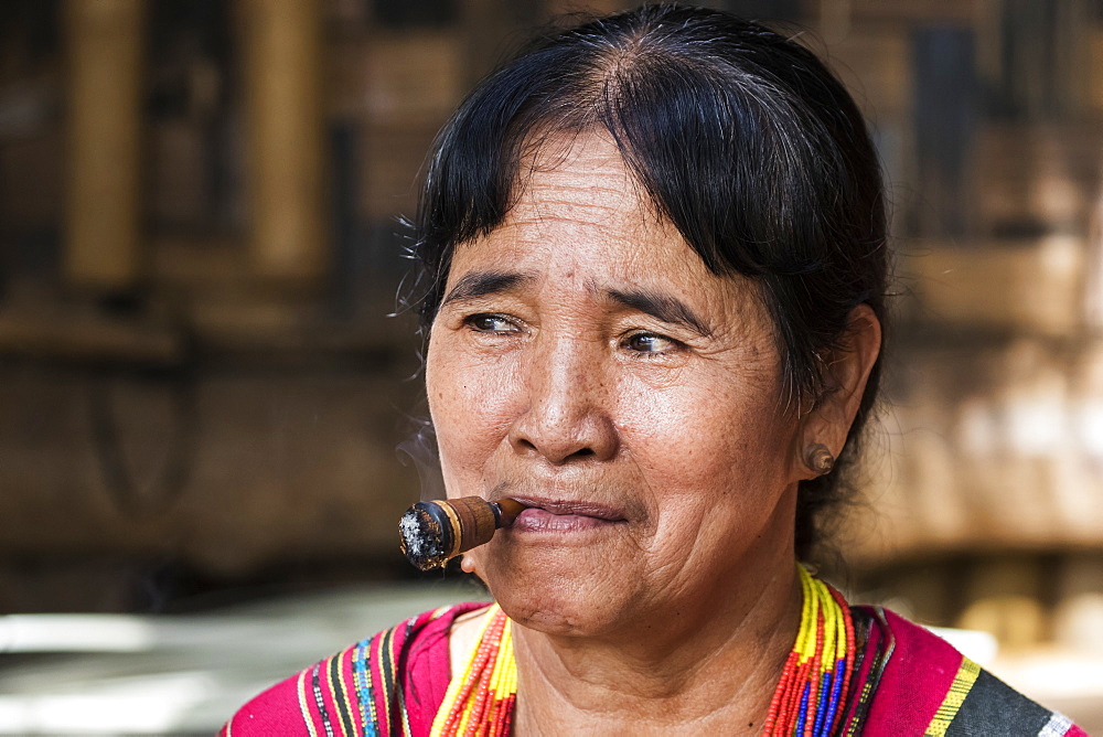 Lavae woman smoking a cigar in the ethnic village at Pha Suam, Bolaven Plateau, Champasak, Laos