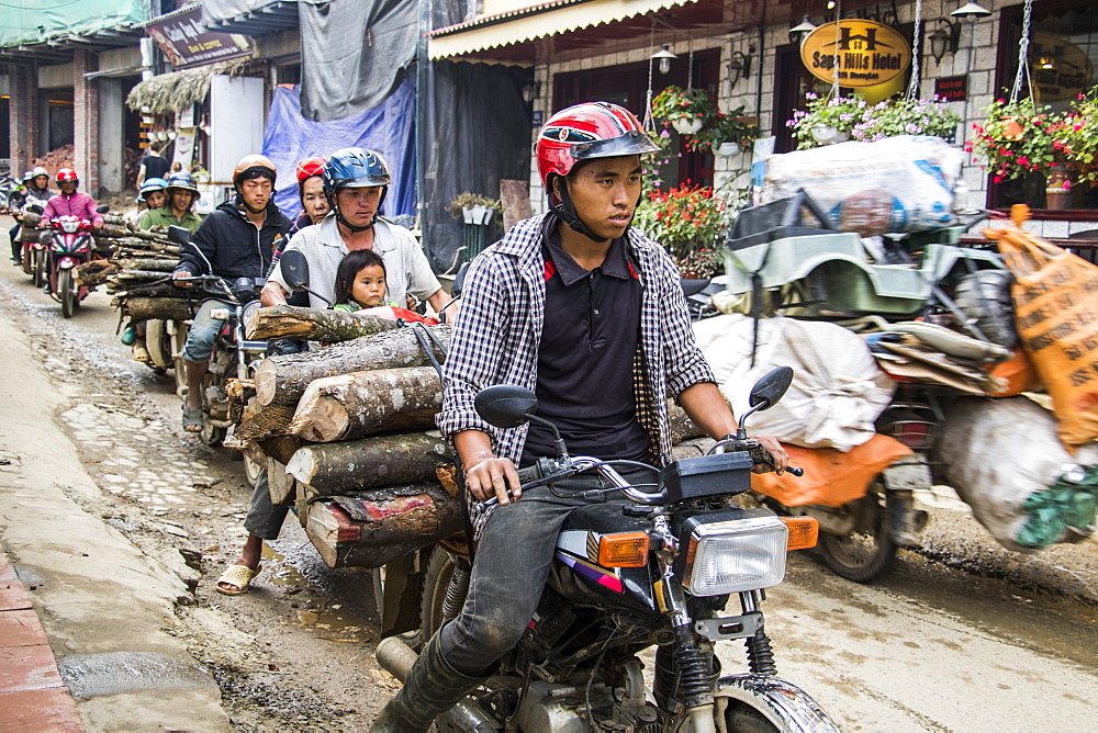 People hauling logs on motorbikes, Sapa, Lao Cai, Vietnam