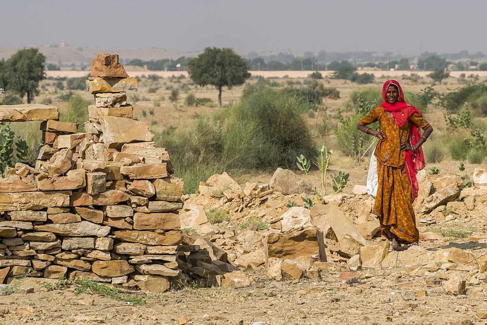 An Indian woman standing in Thar Desert, Jaisalmer, Rajasthan, India