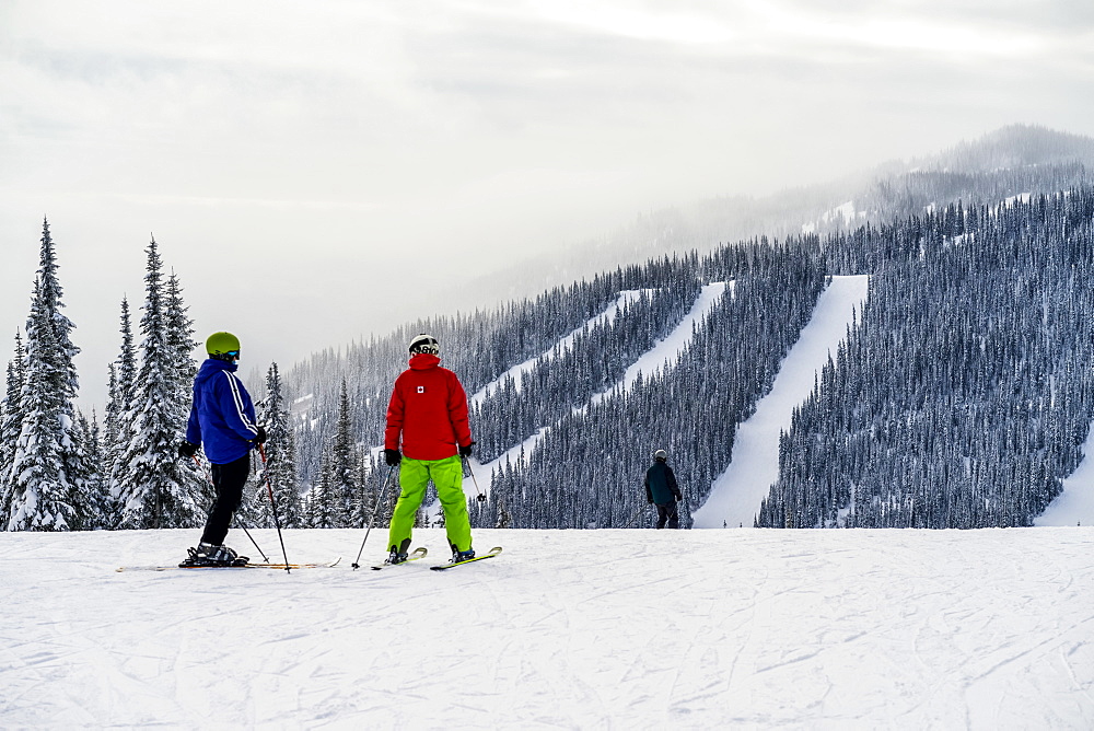 Skiers on a run at Sun Peaks ski resort, Kamloops, British Columbia, Canada