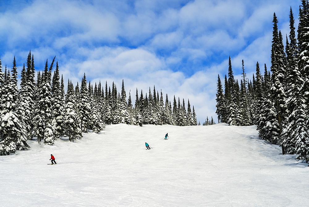 Skiers on a run at Sun Peaks ski resort, Kamloops, British Columbia, Canada