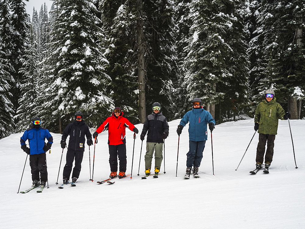 Skiers standing in a row, Sun Peaks Resort, Kamloops, British Columbia, Canada