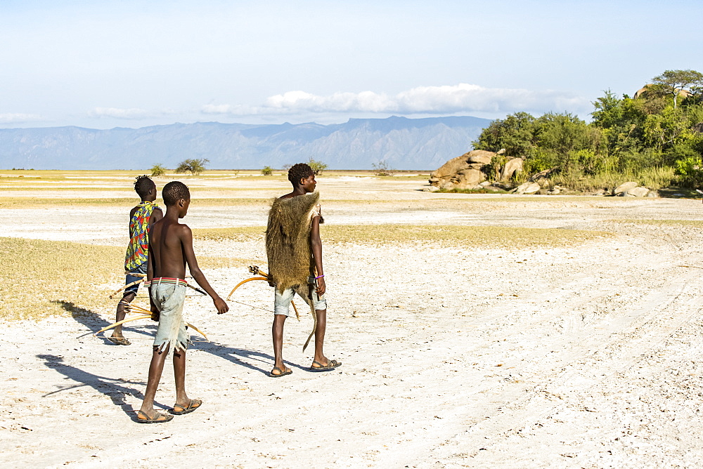 Hadzabe hunters returning to camp after a successful morning hunt near Lake Eyasi, Tanzania