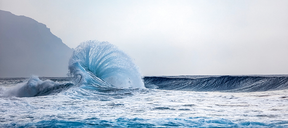 Ocean waves crashing into the shore off the Na Pali coast, Kauai, Hawaii, United States of America