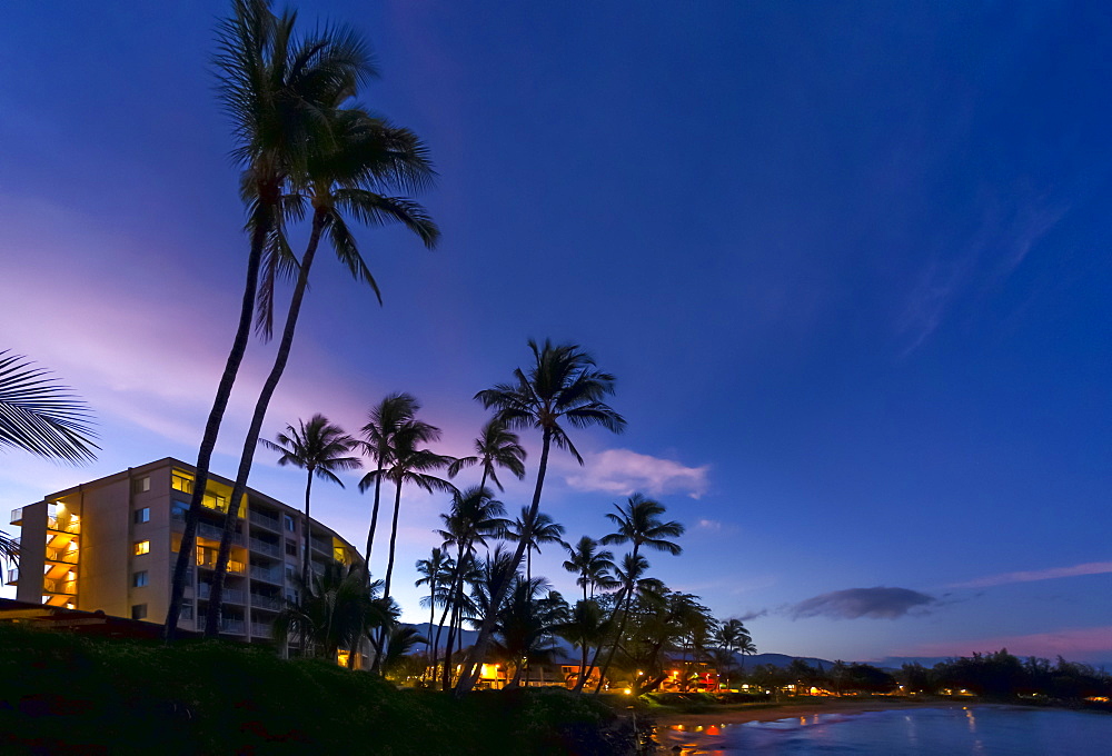 Hotels and palm trees along the coastline at sunset, Kamaole One and Two beaches, Kamaole Beach Park, Kihei, Maui, Hawaii, United States of America