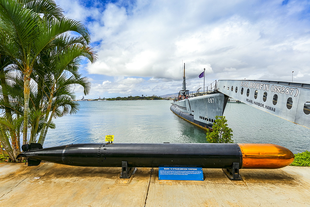 Torpedo display and tourists exploring a submarine at Pearl Harbour, Oahu, Hawaii, United States of America