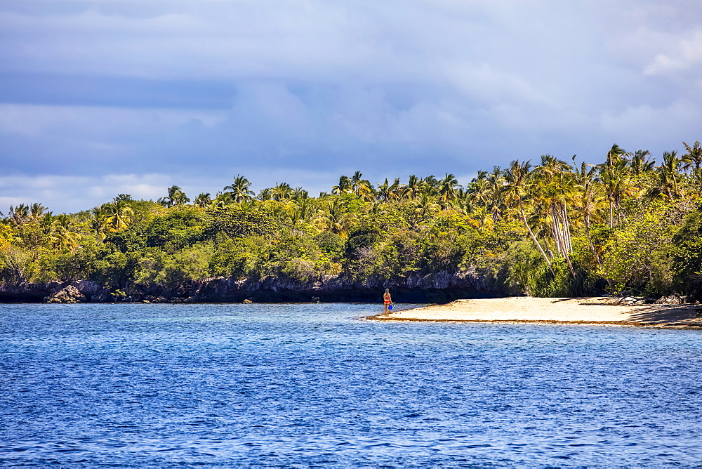 A young woman with snorkel gear alone on a beach, Cabilao Island, Central Visayas, Philippines