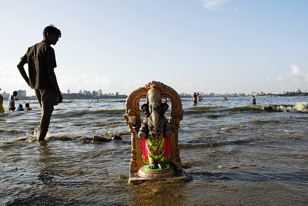 A Ganesha idol washes ashore in Mumbai, Maharashtra, India, Asia