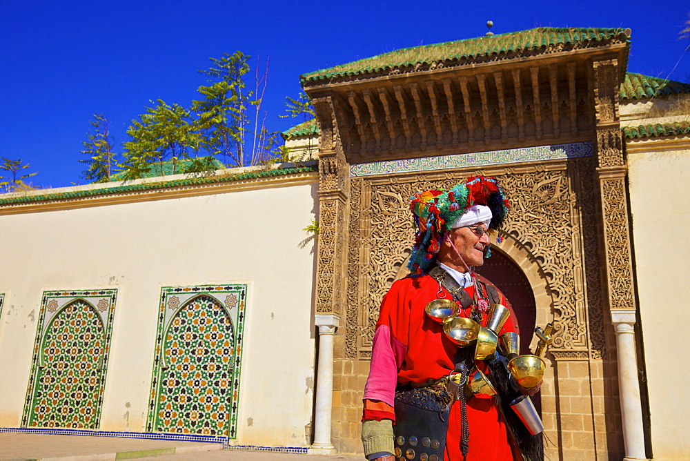 Water Carrier in from of Mausoleum of Moulay Ismail, Meknes, Morocco, North Africa, Africa