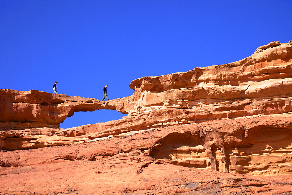 Tourists climbing at Wadi Rum, Jordan, Middle East