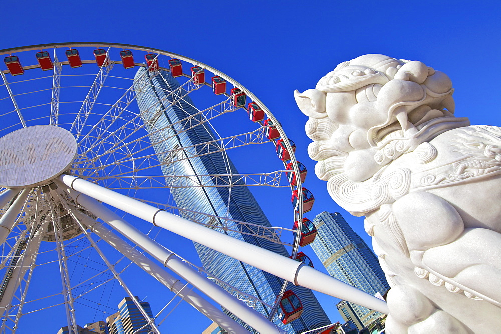 Chinese Guardian Lion with The Hong Kong Observation Wheel and IFC Building, Hong Kong, China, Asia