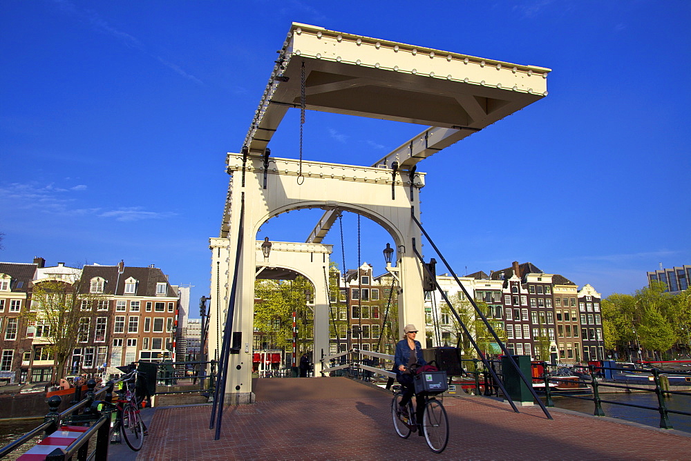 Cyclist on the Magere Brug (Skinny Bridge), Amsterdam, Netherlands, Europe