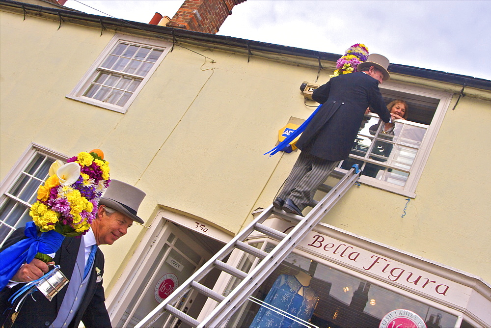 Tutti Man ascending ladder to receive a kiss, Tutti Day, traditional annual Hocktide Festival, Hungerford, Berkshire, England, United Kingdom, Europe