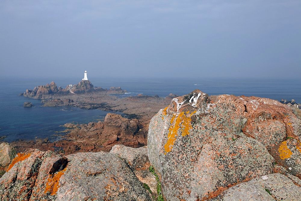 Rocks and the white La Corbiere Lighthouse, Jersey, Channel Islands, United Kingdom, Europe