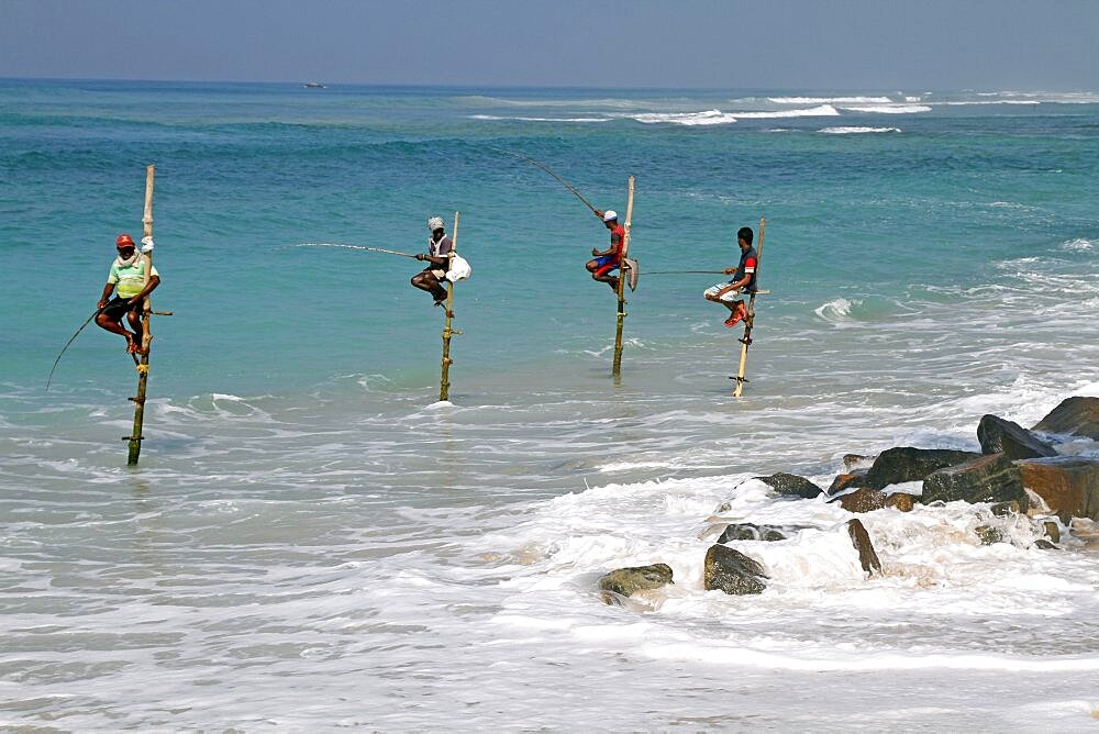 Stilt fishermen and Indian Ocean, Midigama, Sri Lanka, Asia