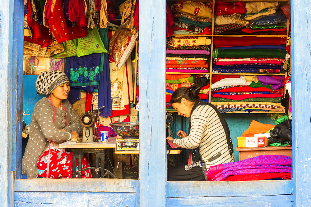 Young Nepalese women working in an open Tailor shop in Bandipur, Tanahun district, Nepal, Asia