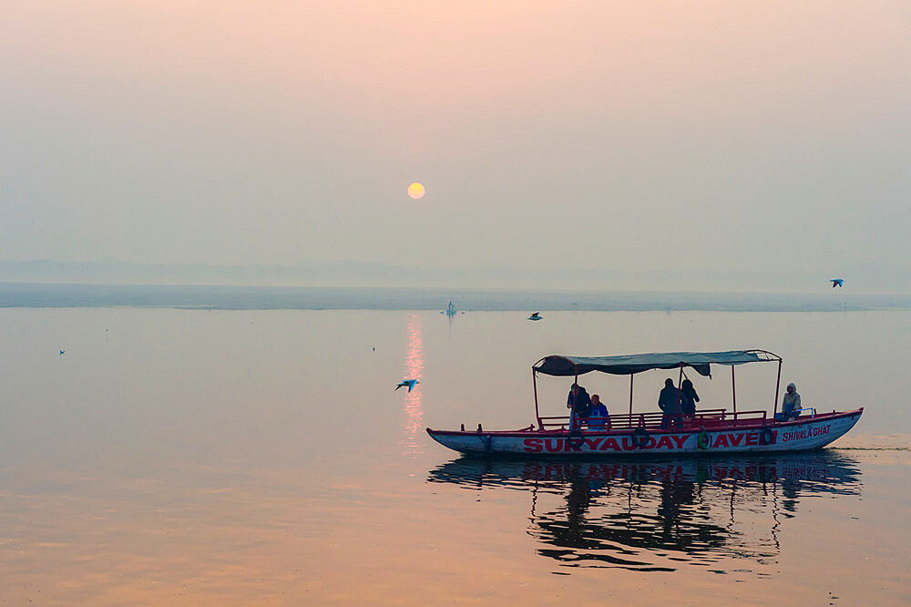 Small boats on Ganges River at sunset, Varanasi, Uttar Pradesh, India, Asia