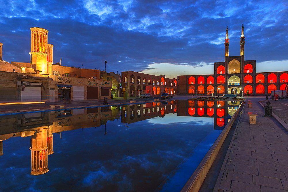 Amir Chaqmaq complex facade illuminated at sunrise and reflecting in a pond, Yazd, Yazd province, Iran, Middle East