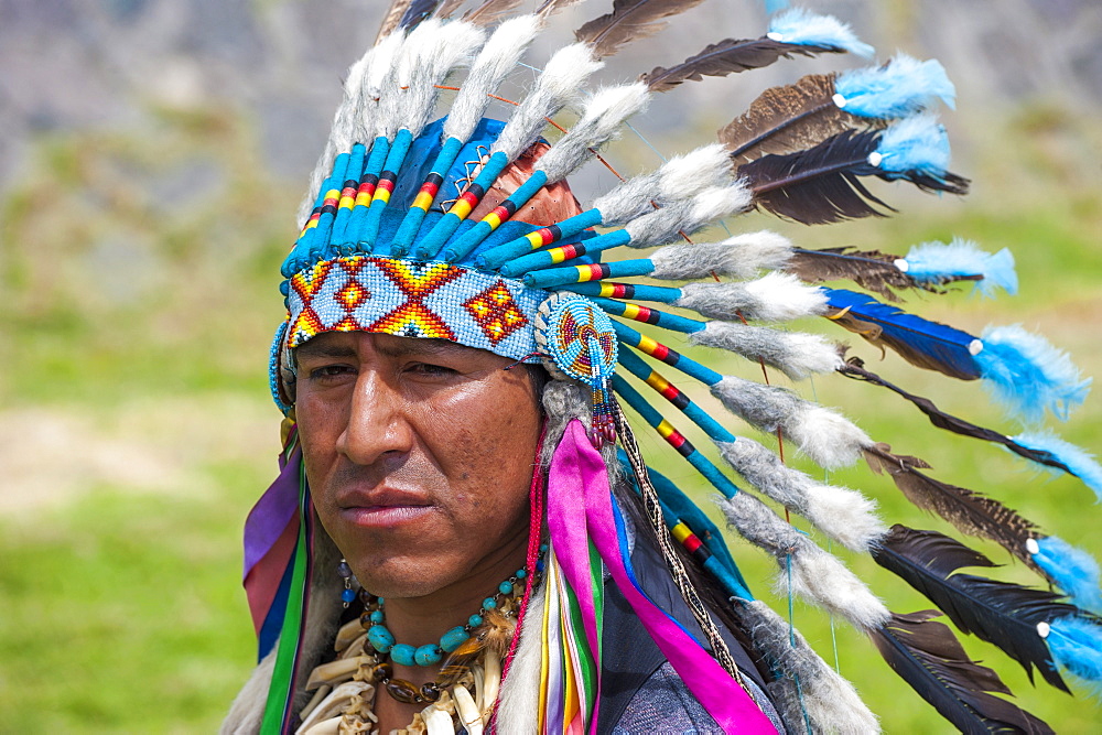 Indigenous man wearing a feather headdress, Quito, Pichincha Province, Ecuador, South America