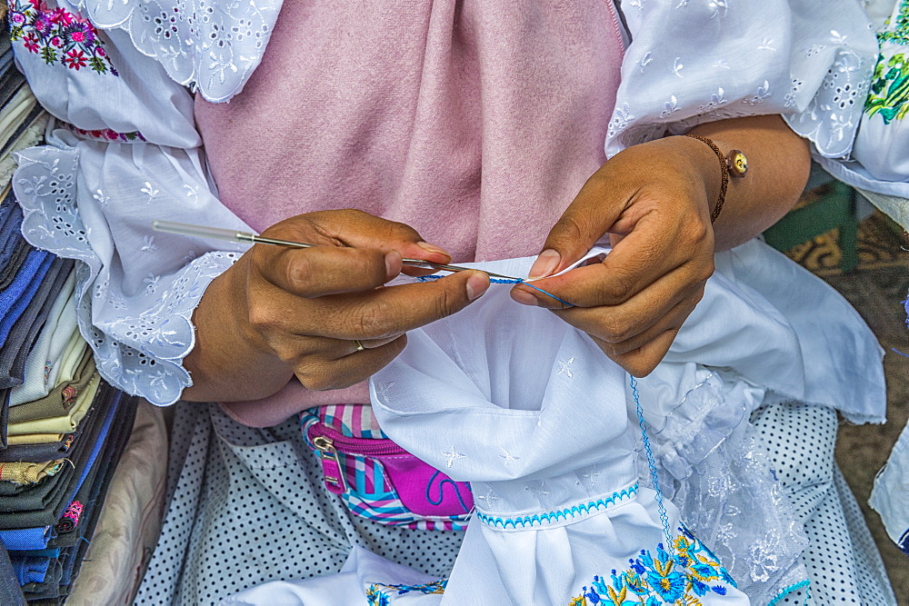 Young woman crocheting, Otavalo market, Imbabura Province, Ecuador, South America 