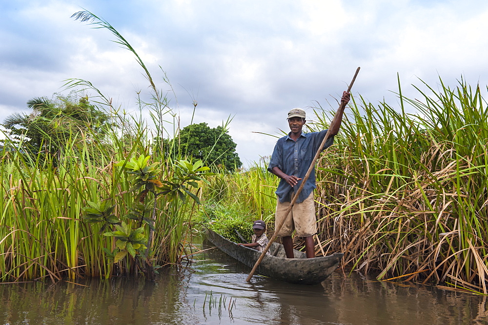 Malagasy man and his son in a small boat, Maroantsetra, Madagascar, Africa