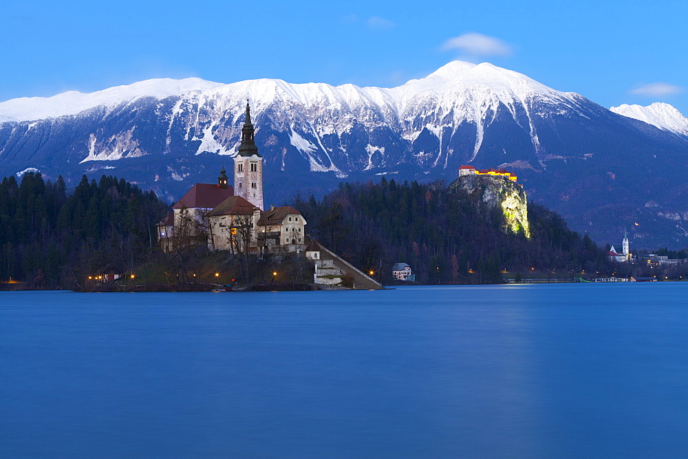 The Assumption of Mary Pilgrimage Church on Lake Bled and Bled Castle at Dusk, Bled, Slovenia, Europe