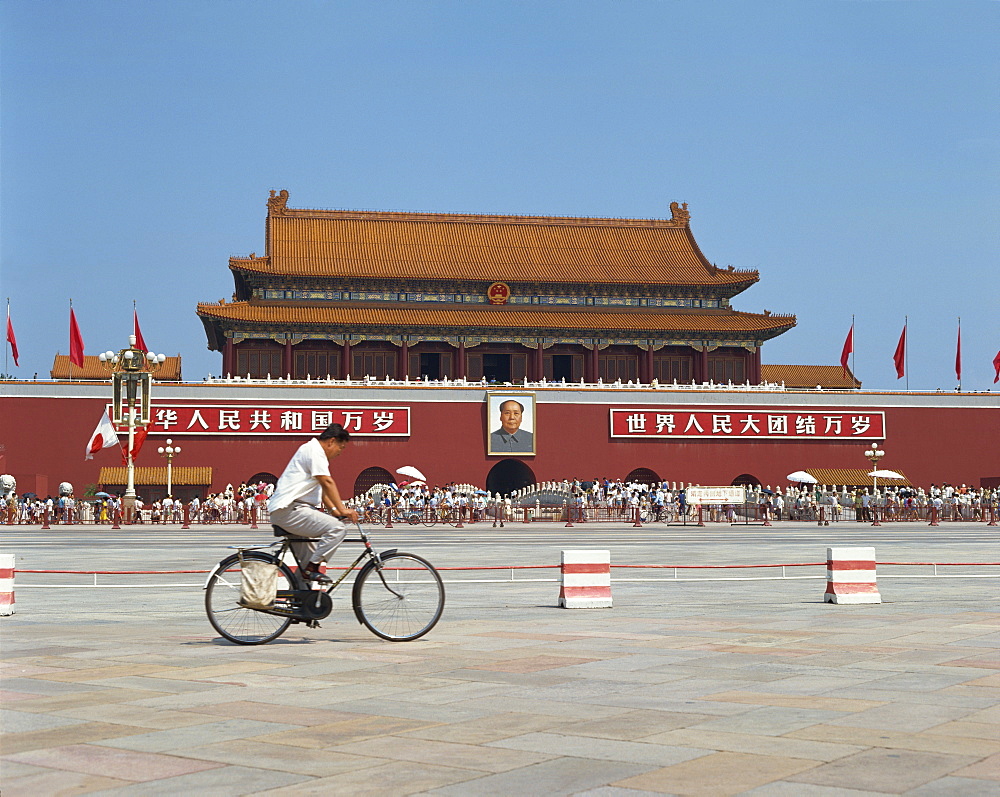 Man cycling through Tiananmen Square with portrait of Mao Tse Tung behind, Forbidden City, Beijing, China, Asia