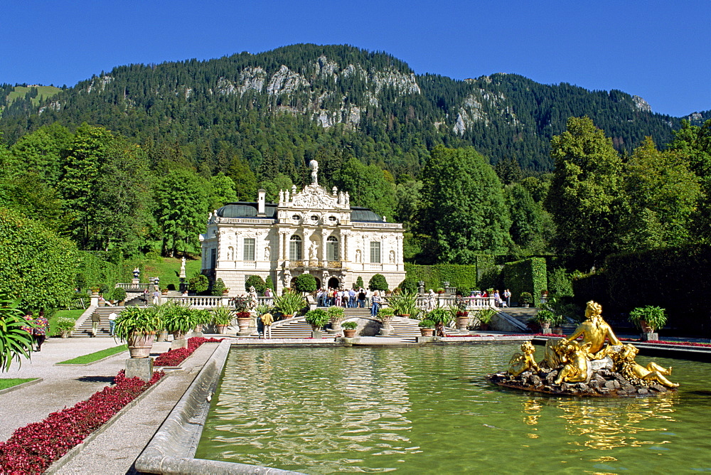 Gilded statues and pool in the gardens in front of Linderhof Castle, Bavaria, Germany, Europe