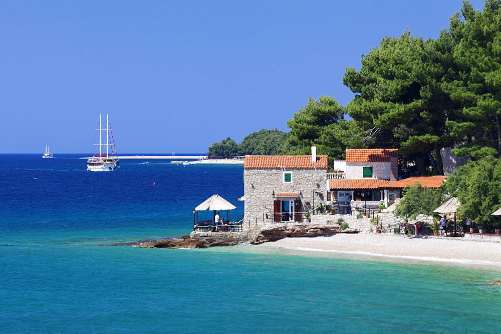 Restaurant at the beach with sailing boat, Bol, Brac Island, Dalmatia, Croatia, Europe