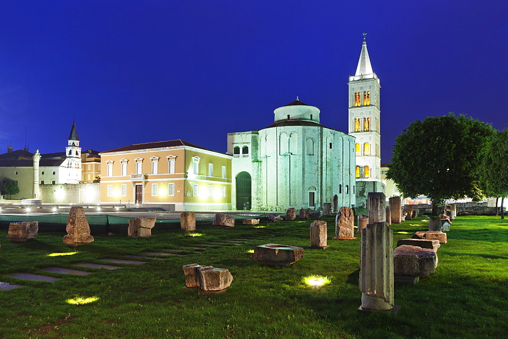 Illuminated Roman forum (Forum Romanum), St. Donat's church and the bell tower of St. Anastasia cathedral at dusk, Zadar, Dalmatia, Croatia, Europe