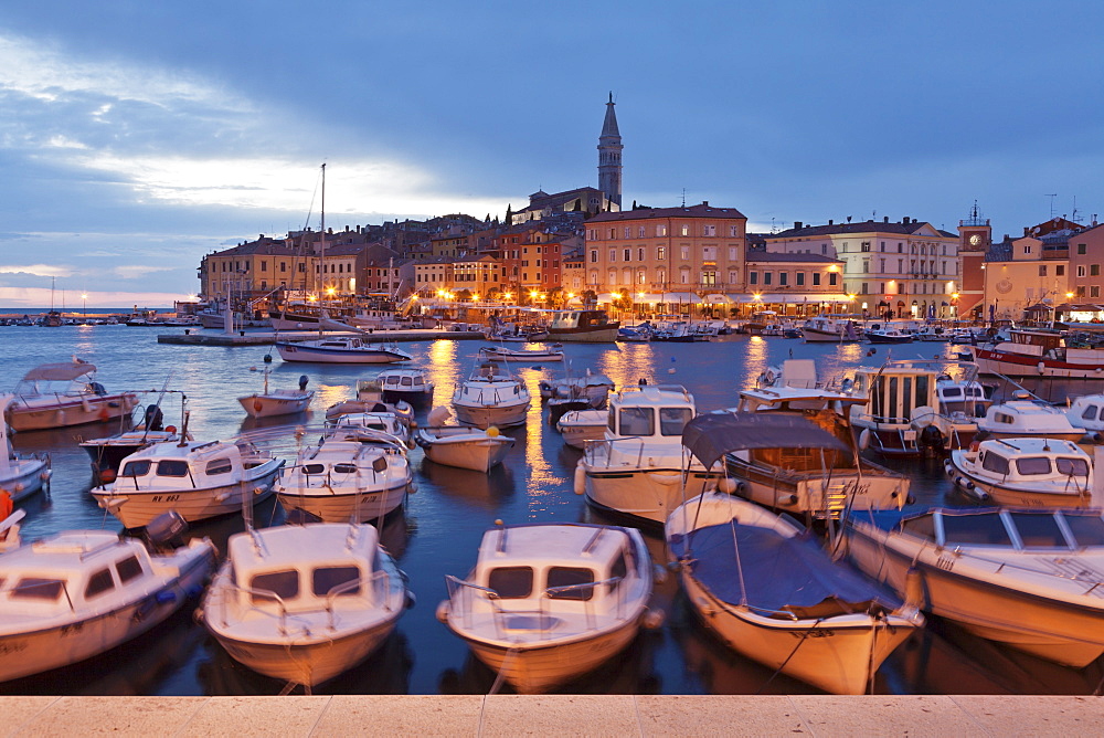 Ships and boats in the harbour and the old town with cathedral of St. Euphemia at dusk, Rovinj, Istria, Croatia, Europe