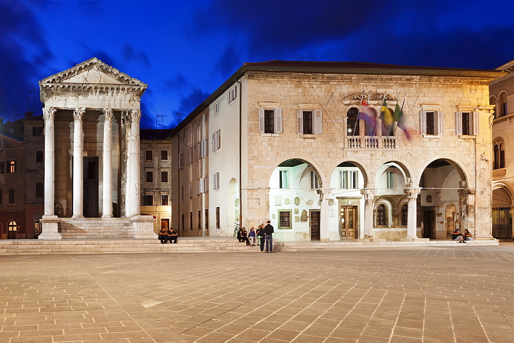 Illuminated Temple of Augustus and town hall on the marketplace in the old town at night, Pula, Istria, Croatia, Europe