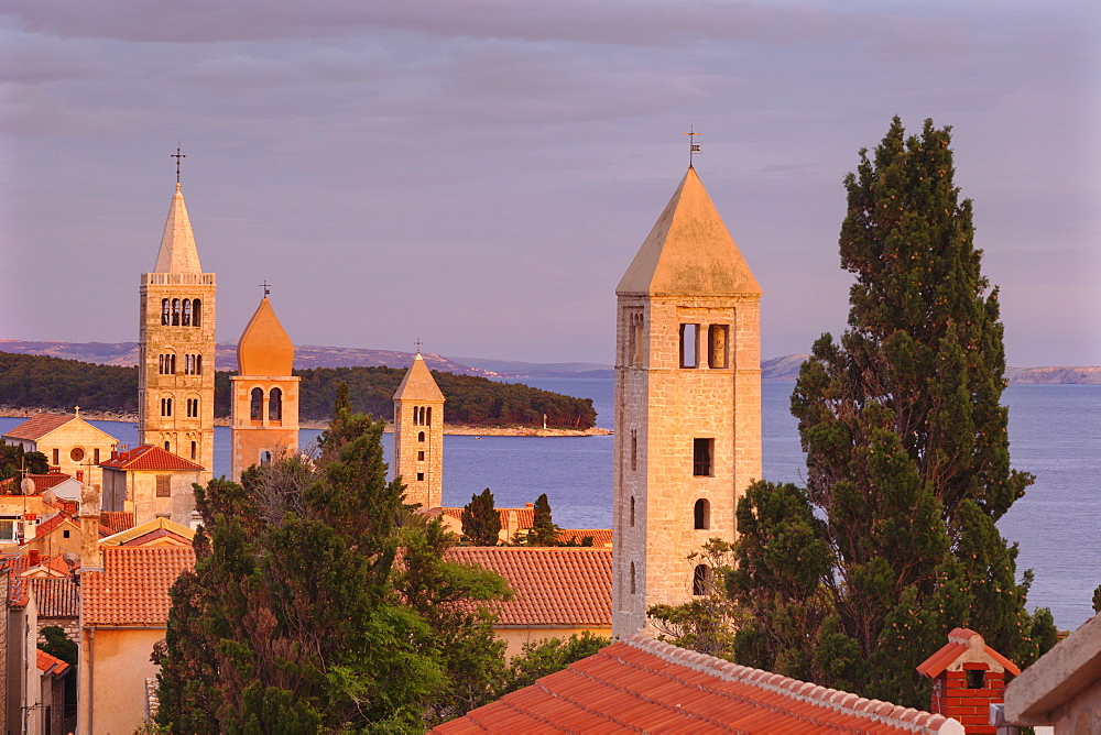 Old town of Rab town with Belfry of St Justine's church, great bell tower of St. Mary's church, campanile of church of St. John and campanile of monastery of St. Andrew at sunset, Rab town, Rab Island, Kvarner region, Dalmatia, Adriatic Sea, Croatia, Europe