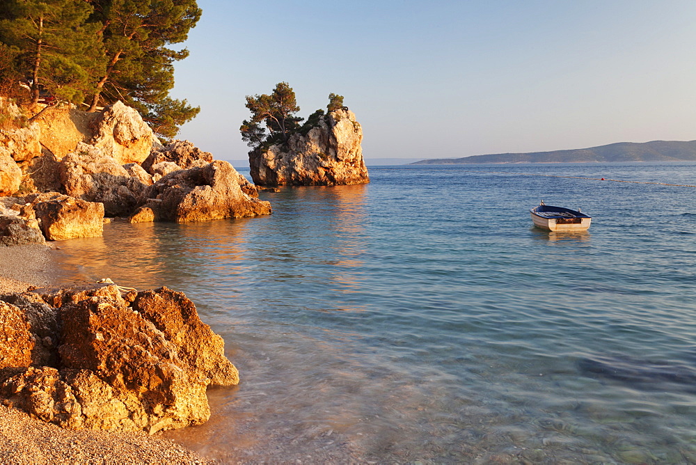 Coastal landscape with a rock and a rowing boat, Brela, Makarska Riviera, Dalmatia, Croatia, Europe 