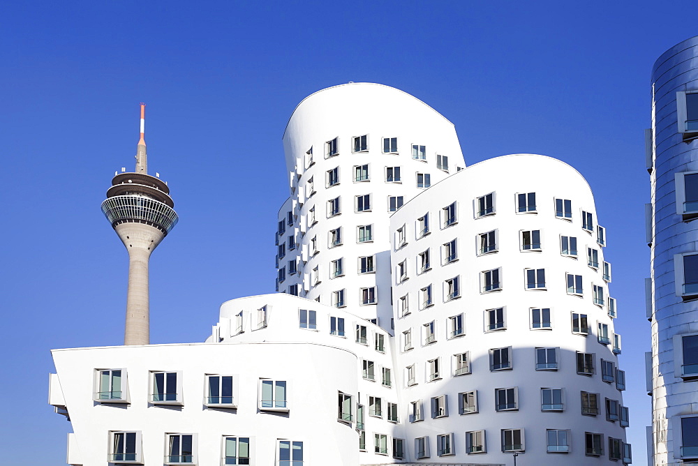 Neuer Zollhof, designed by Frank Gehry, and Rheinturm tower, Media Harbour (Medienhafen), Dusseldorf, North Rhine Westphalia, Germany, Europe 