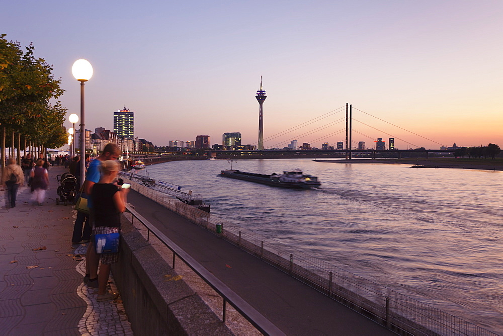 Rhein promenade with Rheinturm tower and Rheinkniebrucke bridge, Dusseldorf, North Rhine Westphalia, Germany, Europe 