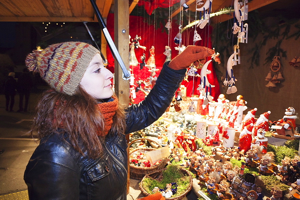 Young woman at the Christmas Fair looking at Christmas decoration, Esslingen am Neckar, Baden Wurttemberg, Germany, Europe 