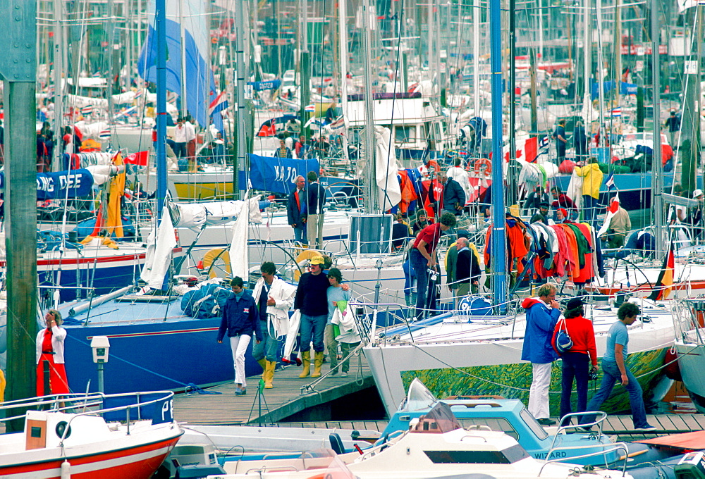 Yachting people at yachting marina in Cowes, Isle of Wight during the famous Cowes Week in August.