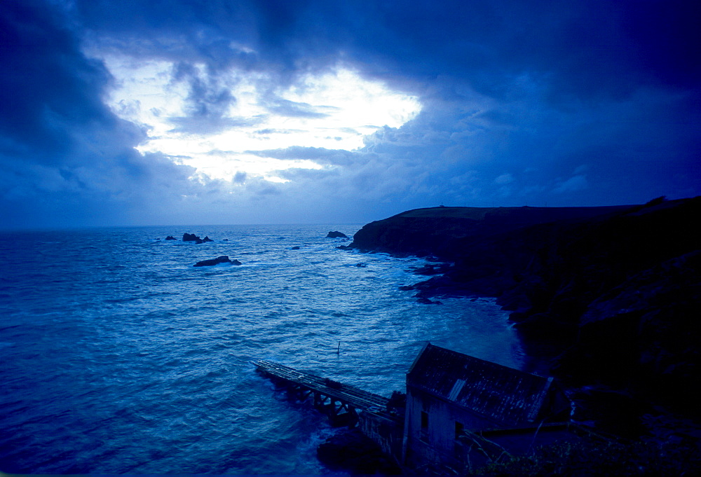 Dusk at Lizard Point in Cornwall, South West England. In the foreground is the old lifeboat station.