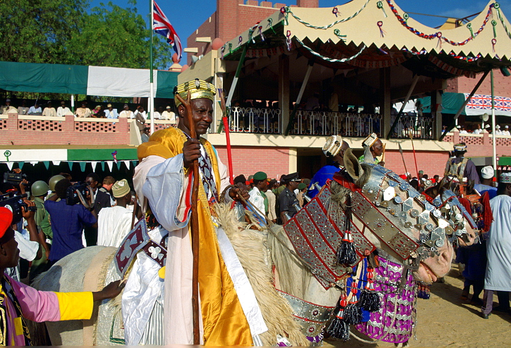 A n honoured chief ridingon a decorated horse and holding a staff at a Durbar in Maidugari, Nigeria